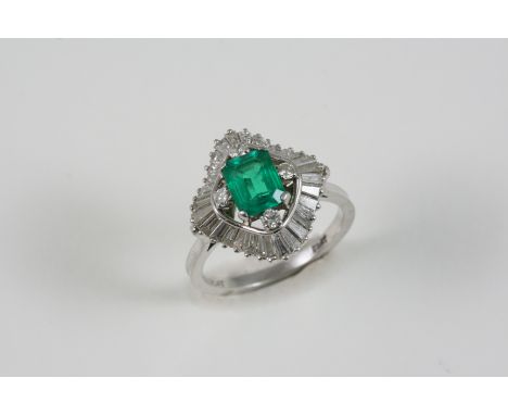 AN EMERALD AND DIAMOND SET 'BALLERINA' CLUSTER RING the octagonal-cut emerald is set within a surround of four circular-cut d