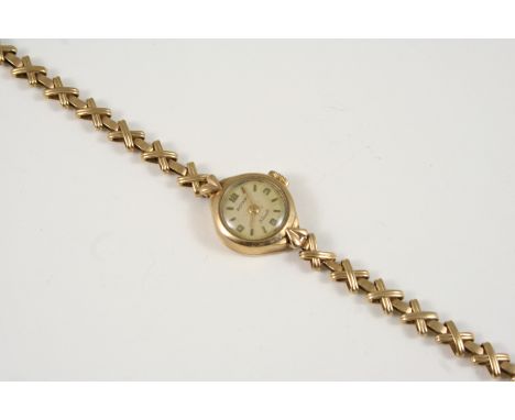 A LADY'S 9CT. GOLD WRISTWATCH BY ROTARY the signed circular dial with Arabic quarters and baton numerals, on a gold cross des