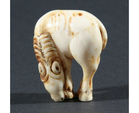 TWO JAPANESE IVORY NETSUKE, the first modelled as a standing horse, height 4.5cm and the other modelled as a rat eating a flo
