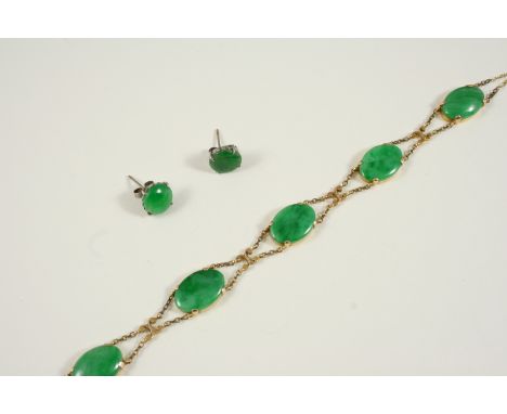 A JADE AND GOLD BRACELET formed with five oval jade cabochons in gold collet settings, 20cm. long, together with a pair of ja