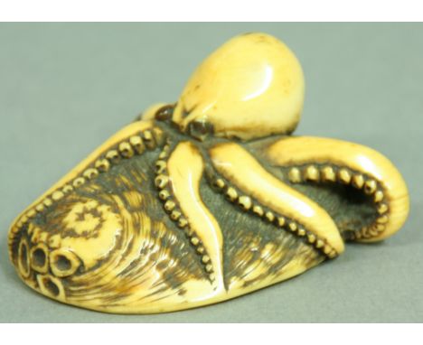 JAPANESE IVORY NETSUKE OF AN OCTOPUS ON A SHELL, Meiji, with tiger's eye eyes, unsigned, 6cm