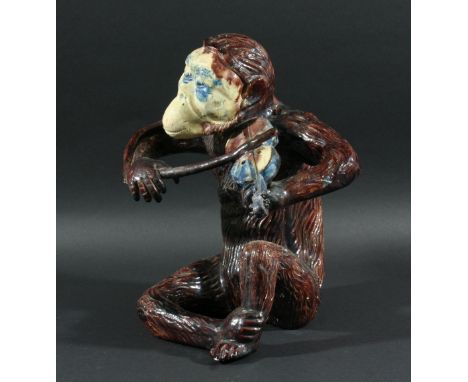 PALISSY STYLE MONKEY a large pottery Monkey playing a Violin, with a brown treacle glaze in the Palissy style. Unmarked, 11 1