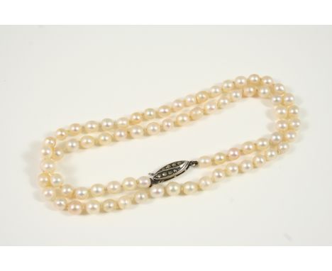 A SINGLE ROW NATURAL PEARL NECKLACE the pearls are set to a marcasite clasp, 46cm. long. Accompanied by report number 13460 f