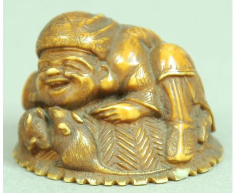 JAPANESE IVORY NETSUKE OF A MAN AND RATS, resting on a basket, signature, diameter 3.5cm; together with another of a man stan