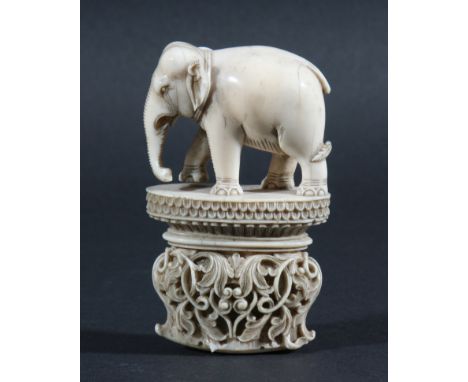 INDIAN IVORY DAGGER HANDLE, late 18th or 19th century, carved as an elephant standing on an oval plinth with bands of stiff l