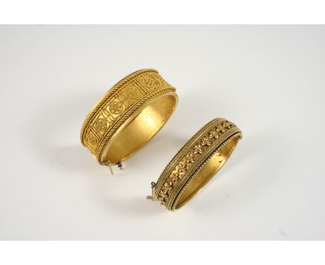A GOLD ETRUSCAN STYLE HALF HINGED BANGLE with gold applied cannetille decoration to one side, 32.1 grams, together with anoth