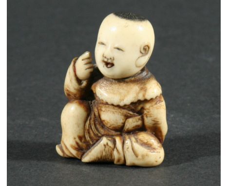 TWO JAPANESE NETSUKE, of a boy seated hiding a mask behind his back, height 3.7cm, the other carved as a man seated holding a