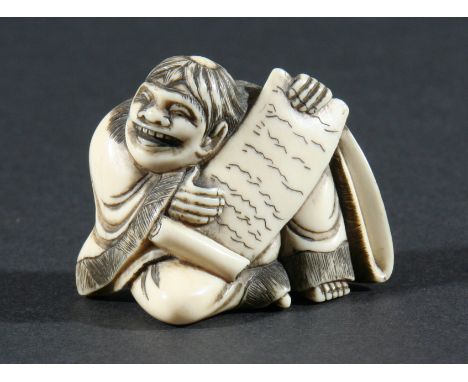JAPANESE IVORY NETSUKE, carved as a grinning man holding a scroll, height 4.5cm