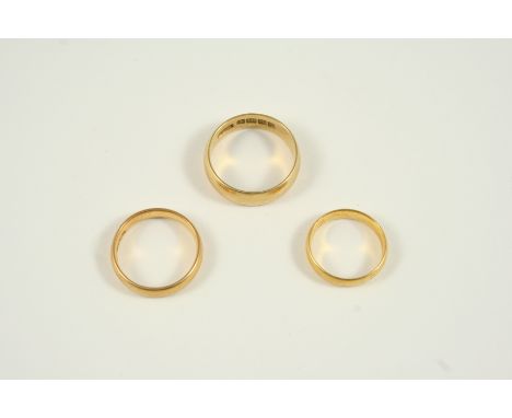 AN 18CT. GOLD WEDDING BAND 6.3 grams, size R, together with two 22ct. gold wedding bands, sizes M and H 1/2, 8.0 grams for bo