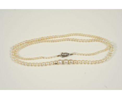 A SINGLE ROW GRADUATED NATURAL PEARL NECKLACE the pearls are set to a marquise-shaped clasp set with three diamonds, 49cm. lo