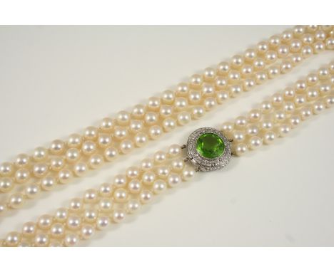 A THREE ROW SLIGHTLY GRADUATED CULTURED PEARL NECKLACE the pearls graduate from approximately 7.2 to 8.2mm., and are set to a