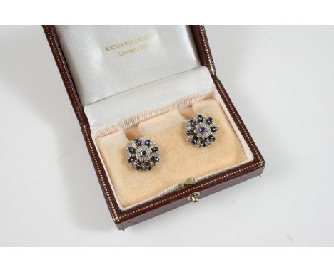 A PAIR OF SAPPHIRE AND DIAMOND CLUSTER EARRINGS each flowerhead centred with a circular-cut sapphire within a surround of sin