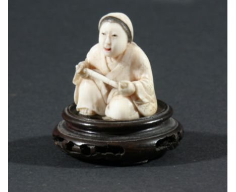 THREE JAPANESE NETSUKE, the first carved as a kneeling lady, height 3.5cm, together with a man asleep in a bowl, 3.8cm and tw