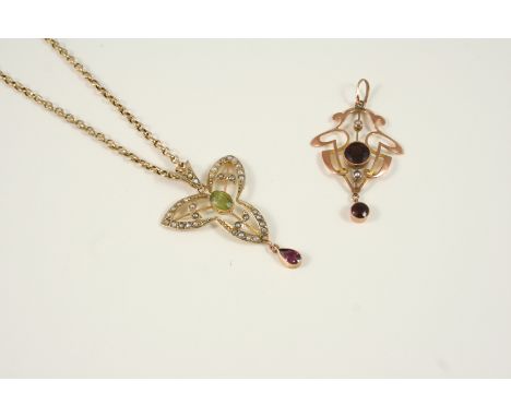 AN EDWARDIAN PEARL AND GEM SET PENDANT the 9ct. gold openwork pendant is centred with an oval-shaped peridot, set overall wit