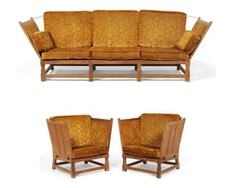 A Derek ''Fishman'' Slater Panelled Oak Three Piece Suite, comprising a sofa, with drop-ends, on four turned octagonal and bl