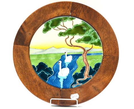 A Continental Art Nouveau Circular Plaque, tube lined with swans on a river landscape, impressed marks 1889/30, 30cm in an oa