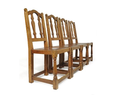 A Set of Four 1920's/30's Robert ''Mouseman'' Thompson Oak Chairs, with shaped top rail, vase splats, the uprights with carve