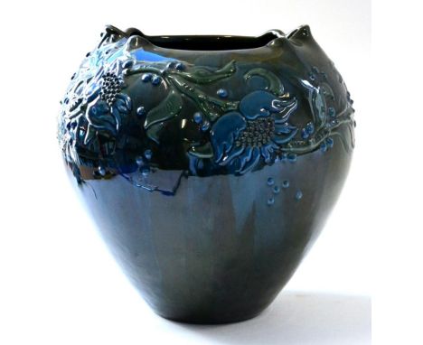 A Sunflower Pottery Vase, by Sir Edmund Elton, with applied foliate decoration on a green/blue ground, painted Elton mark, 23