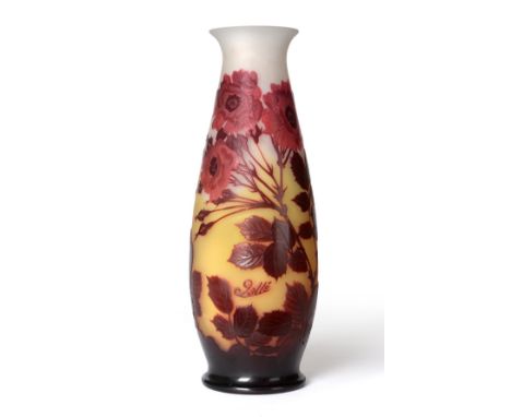 An Emile Gallé Cameo Vase, tall slender form with flared rim, acid etched with roses in tones of browns and reds, on a yellow