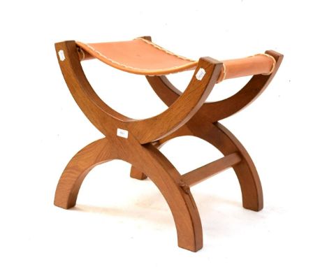 A Robert ''Mouseman'' Thompson Oak X Framed Stool, the slung hide seat supported by two X legs, joined by side rails, with ca