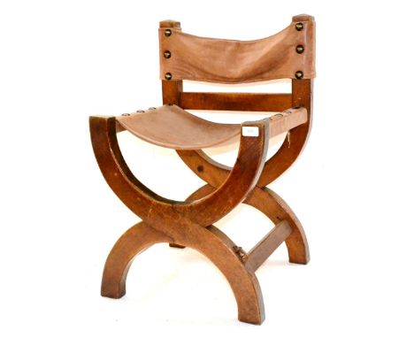 A Robert ''Mouseman'' Thompson Oak Pub Stool, the cross-frame with slung hide seat and back, with carved mouse signature, 73c