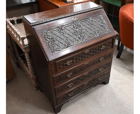 A profusely carved mahogany fall front bureau with fitted interior and four long drawers raised on bracket feet, 78 cm wide, 