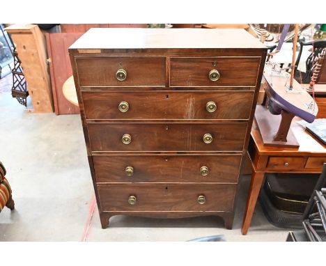 A 19th century large mahogany chest of two short over four long drawers cut into two sections, with brass handles, raised on 