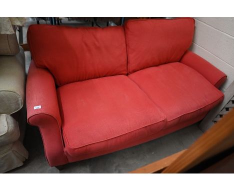 A two seater scroll arm sofa in raspberry fabric upholstery, tapering square hardwood supports, 178 cm wide x 98 cm deep x 90