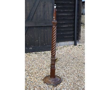 A turned and carved mahogany standard lamp with spiral reeded column and circular platform base, 159 cm overall