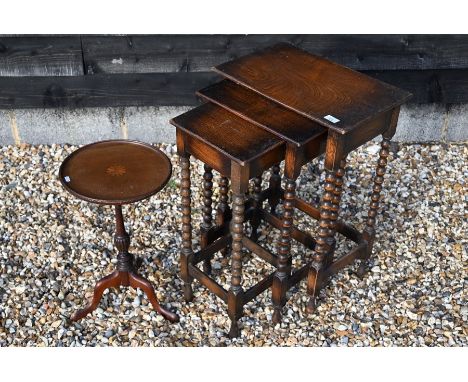 A small inlaid mahogany circular wine table on turned column and triform supports to/w a nest of three rectangular oak tables