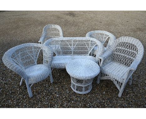 A cream painted wicker conservatory suite comprising two seater sofa, pair of armchairs and circular table to/w a similar pai