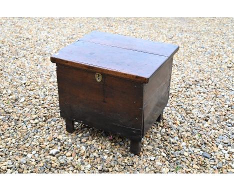 A small 18th century oak trunk with hinged top, standing on stile/block supports, 51 cm wide x 44 cm deep x 45 cm high