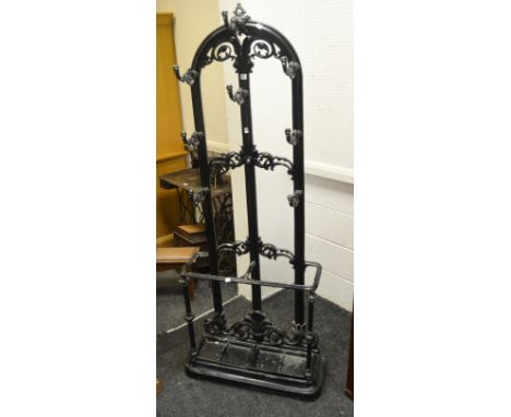 A 19th century cast iron hall stand, in the manner of Coalbrookedale, arched back with 8 hooks, the base with stick stand, c.