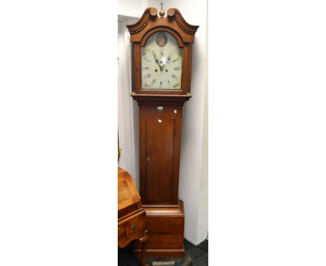 An oak longcase clock by Thos Wilson, Peterboro, brass turned finial, broken swan neck pediment, arched painted dial, Roman n