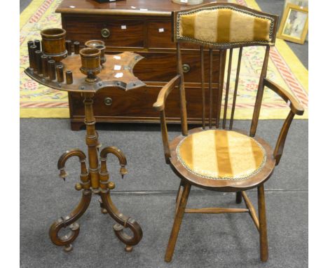 An early 20th Century cottage-craft made smokers' stand, shield shaped top with pipe rests, ash trays and tobacco pots, turne