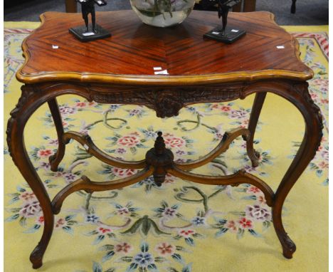 A reproduction mahogany occasional table, shaped rectangular quarter veneered top, floral carving to frieze, cabriole support