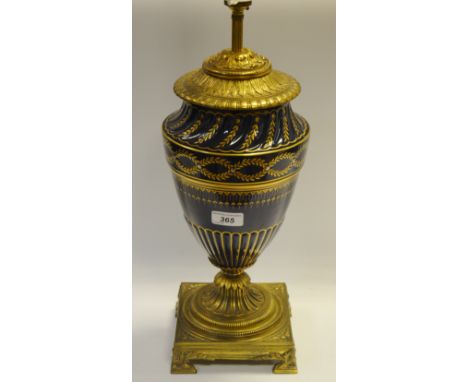 A decorative gilt-metal mounted cobalt blue urnular lamp.