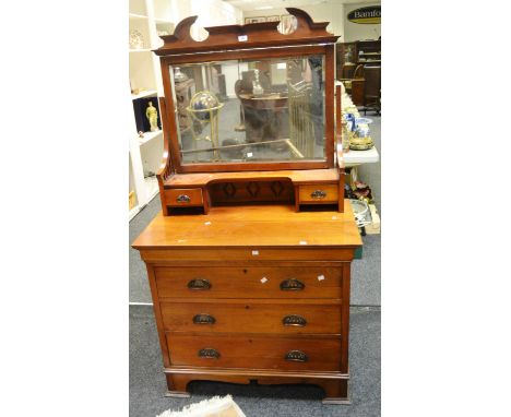 An Arts and Crafts flame mahogany dressing chest, cresting pediment, rectangular glass, shelf and two short drawers to the su