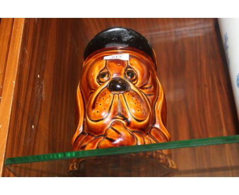 A BROWN CERAMIC DOG SHAPED BISCUIT BARREL