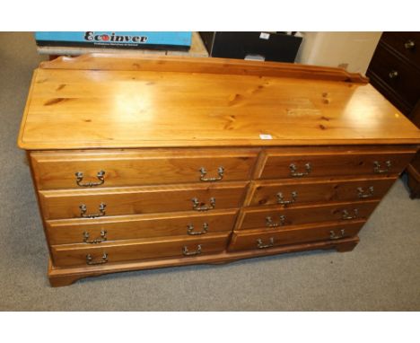 A LARGE PINE BEDROOM CHEST OF EIGHT DRAWERS