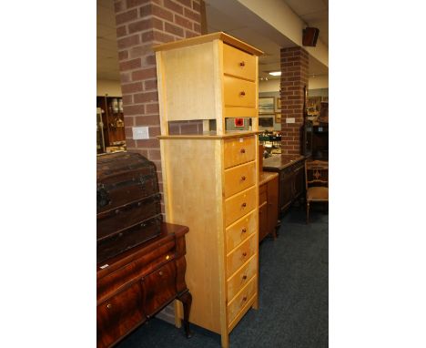 A LIGHT WOOD TALL CHEST OF SEVEN DRAWERS TOGETHER WITH A TWO DRAWER SIDE TABLE