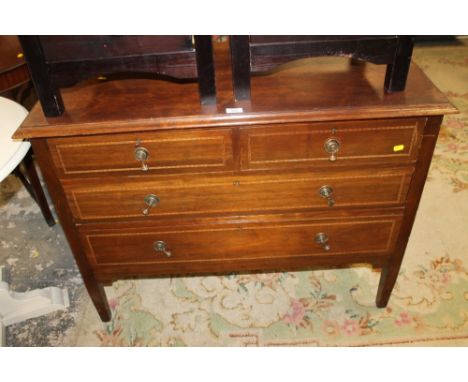 AN INLAID TWO OVER TWO CHEST OF DRAWERS