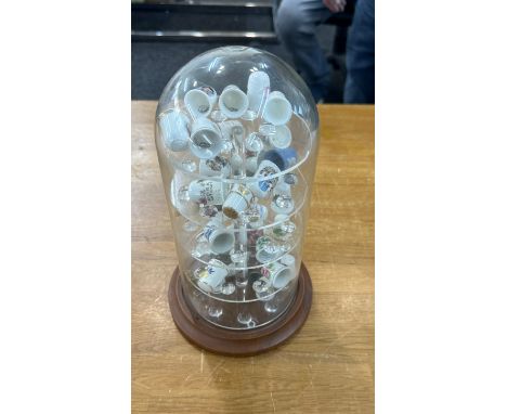 Vintage glass dome with a selection of assorted thimbles 