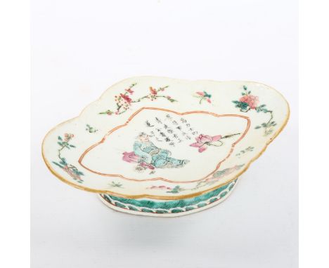 A Chinese oval porcelain dish on foot, with painted enamel decoration and text, length 23cm 