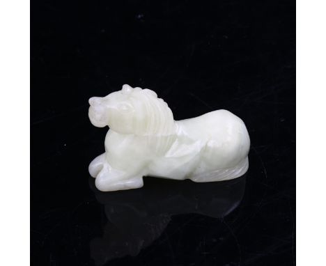 A Chinese pale green jade horse, length 8cm 