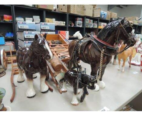 A Beswick study, Burnham Beauty 2309 and two similar smaller shire horse studies, all with carts and harnessCONDITION REPORTT