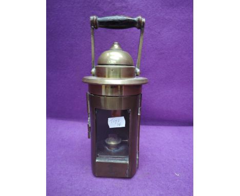 A brass Piper Montreal hanging oil lamp having clear glass window and wood handle