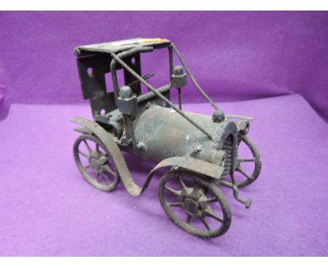 A hand made metal model vintage car, made out of hinges, springs. Bolts and similar spare partsCONDITION REPORTHeight 6,5 inc