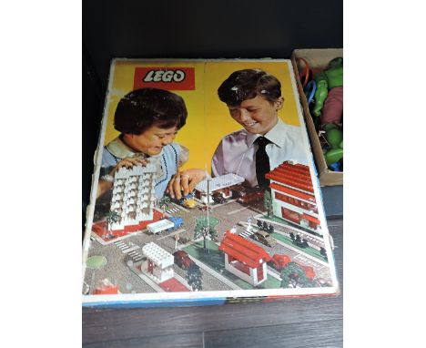 A 1960's Lego part set no 810 having Fold Out Street Plan, Esso Tanker, Transport Van, Recovery Truck, Ladder Truck, Flat Bed