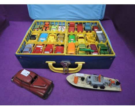 A Brevete France tin plate and clockwork car, model 2002, a Dinky Sea Patrol Boat and a Matchbox Carry Case containing two tr